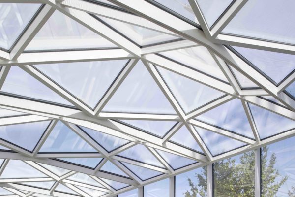 Triangle-shaped, angled glass panels forming a ceiling.