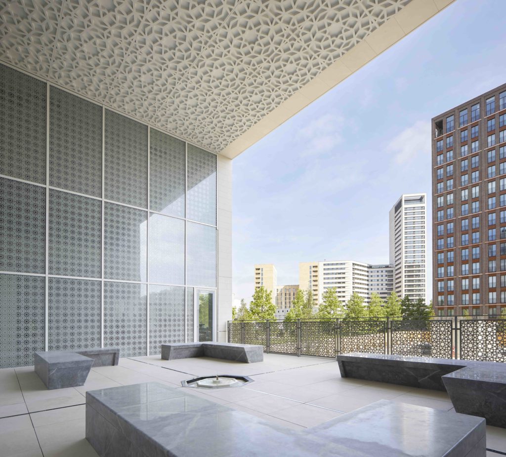 The Garden of Tranquillity - a stripped back, inset plantless garden with marble benches and a small fountain in the middle.