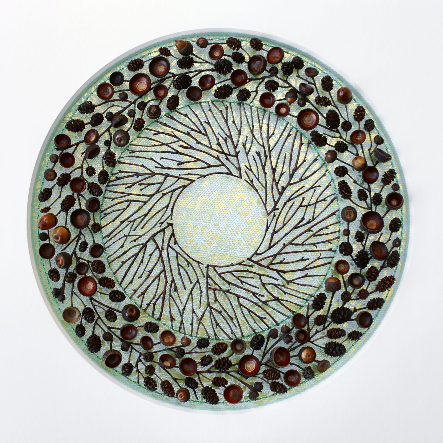 A circle created with plain twigs and twigs with berries on them.