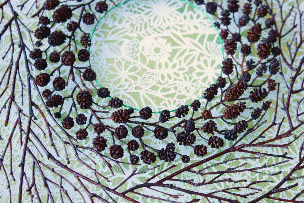 A wreath of berry-twigs surrounded by another circle of twigs.
